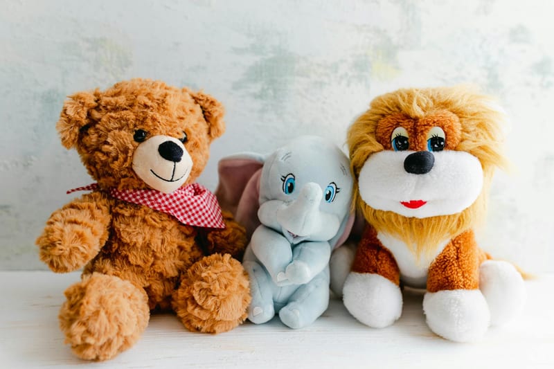 Adorable plush toys featuring a teddy bear, lion, and elephant perfect for children